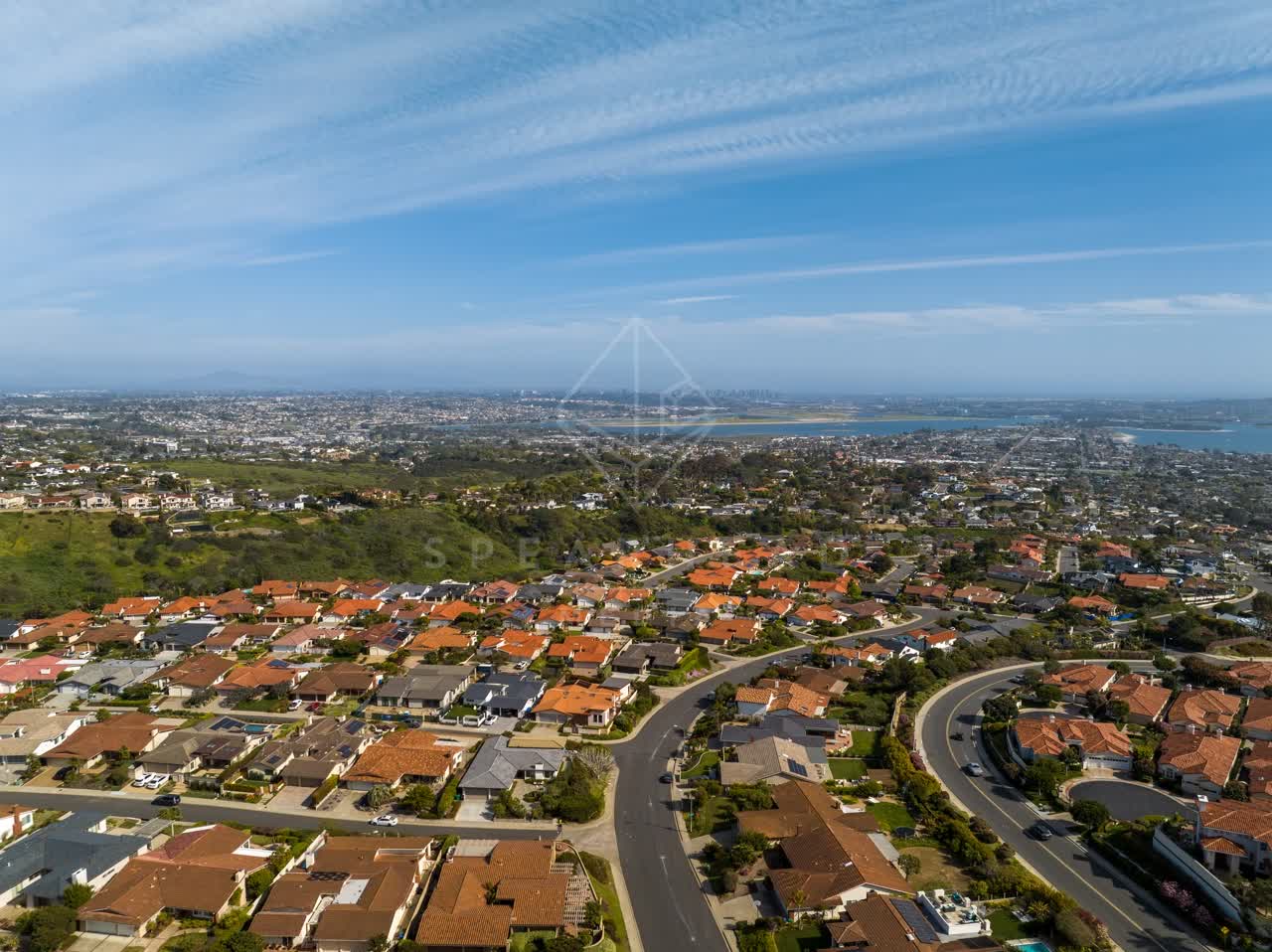 Aerial view of a residential street, the bay and homes at La Jolla Alta.