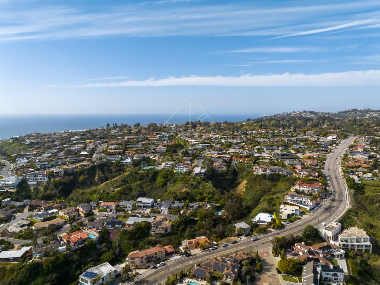 Aerial view of a residential street, the ocean and homes at La Jolla Mesa.