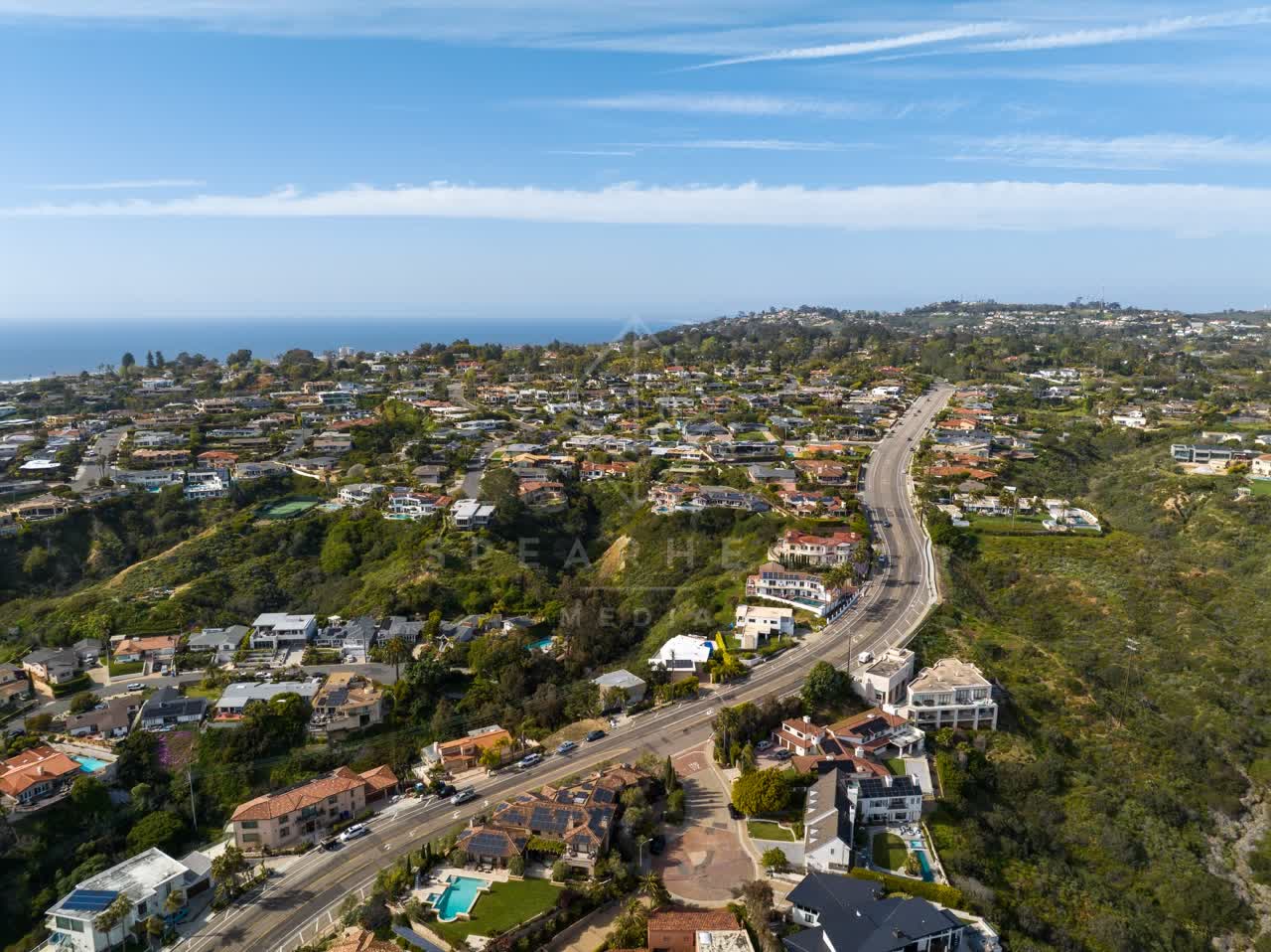 Aerial view of a residential street, the ocean and homes at La Jolla Mesa.