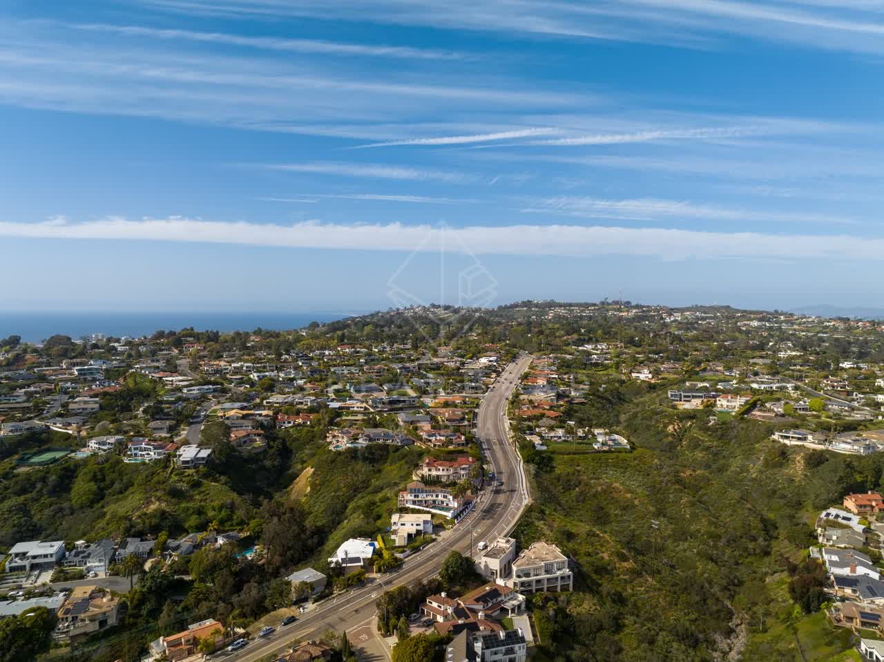 Aerial view of a residential street, the ocean and homes at La Jolla Mesa.