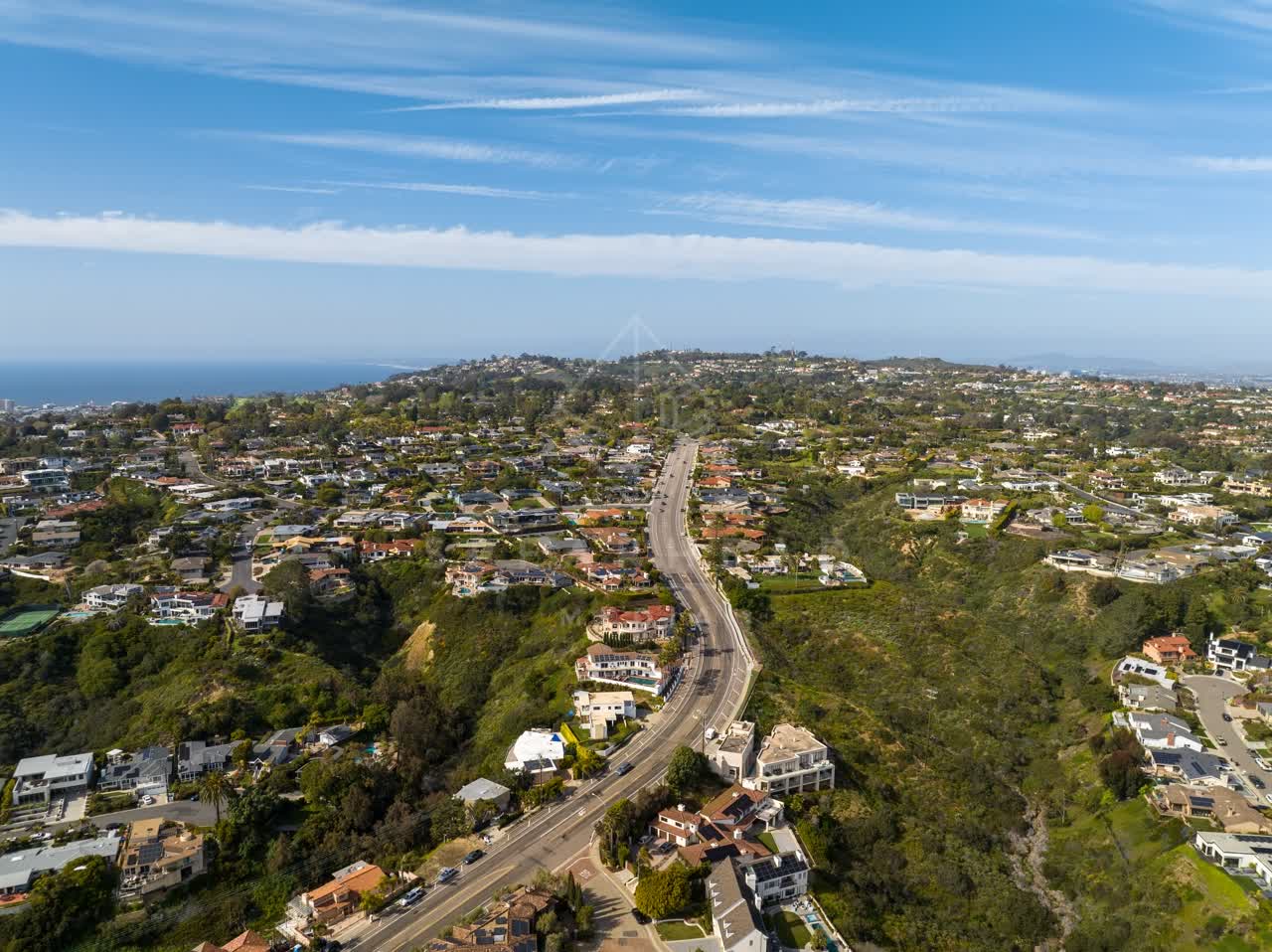 Aerial view of a residential street, the ocean and homes at La Jolla Mesa.