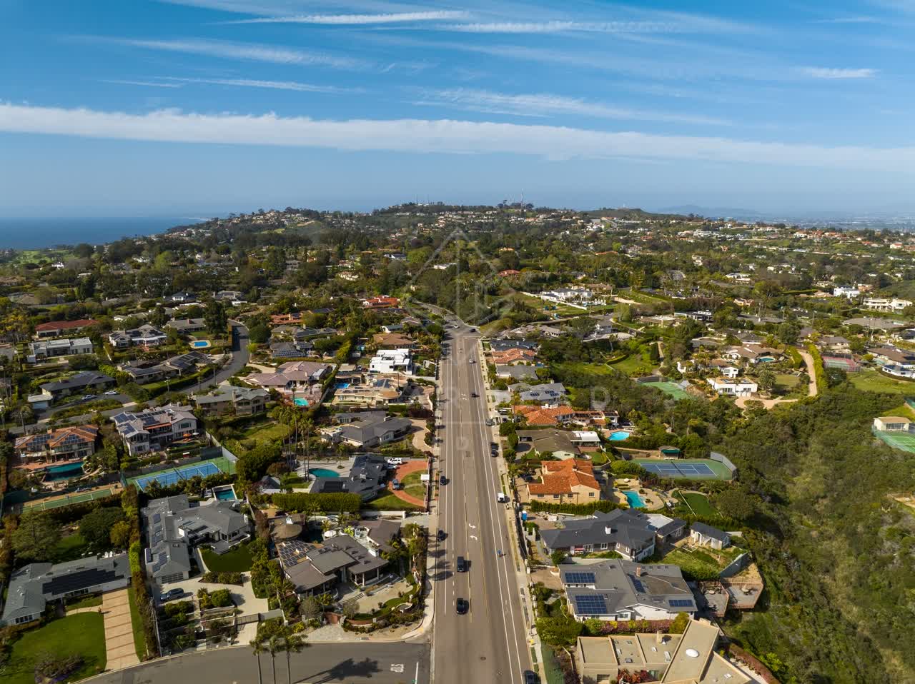 Aerial view of a residential street, the ocean and homes at La Jolla Mesa.