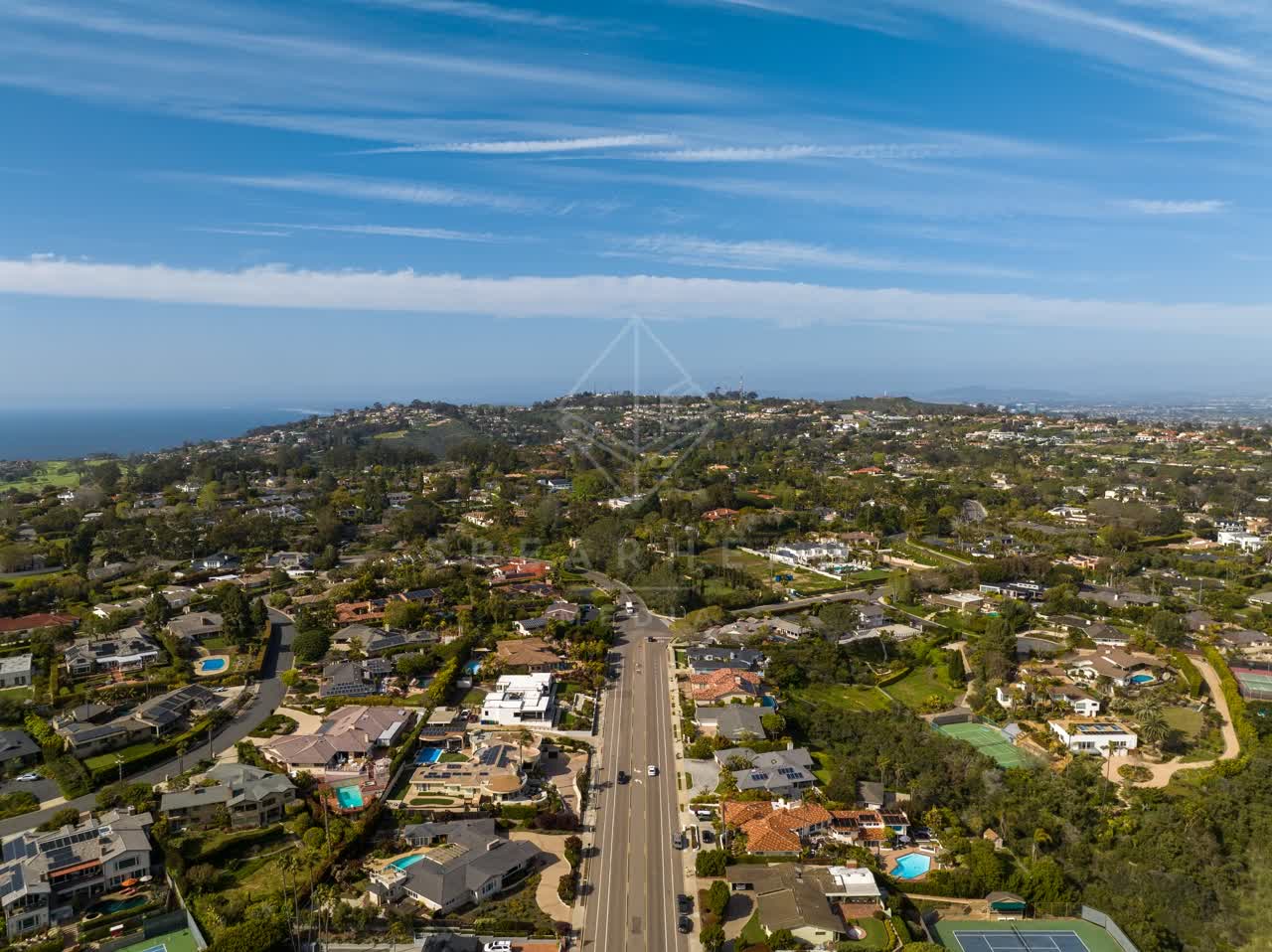 Aerial view of a residential street, the ocean and homes at La Jolla Mesa.