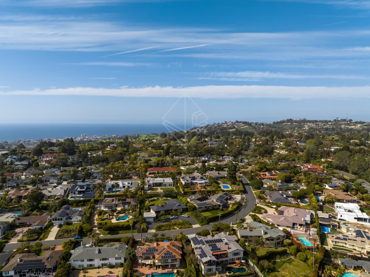 Aerial view of a residential street, the ocean and homes at La Jolla Mesa.