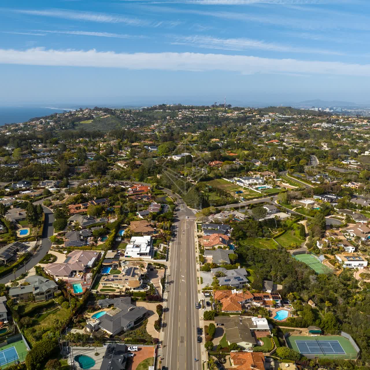 Aerial view of a residential street, the ocean and homes at La Jolla Mesa.