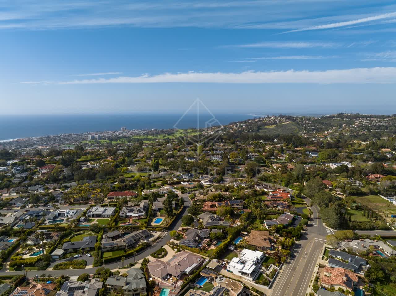 Aerial view of a residential street, the ocean and homes at La Jolla Mesa.