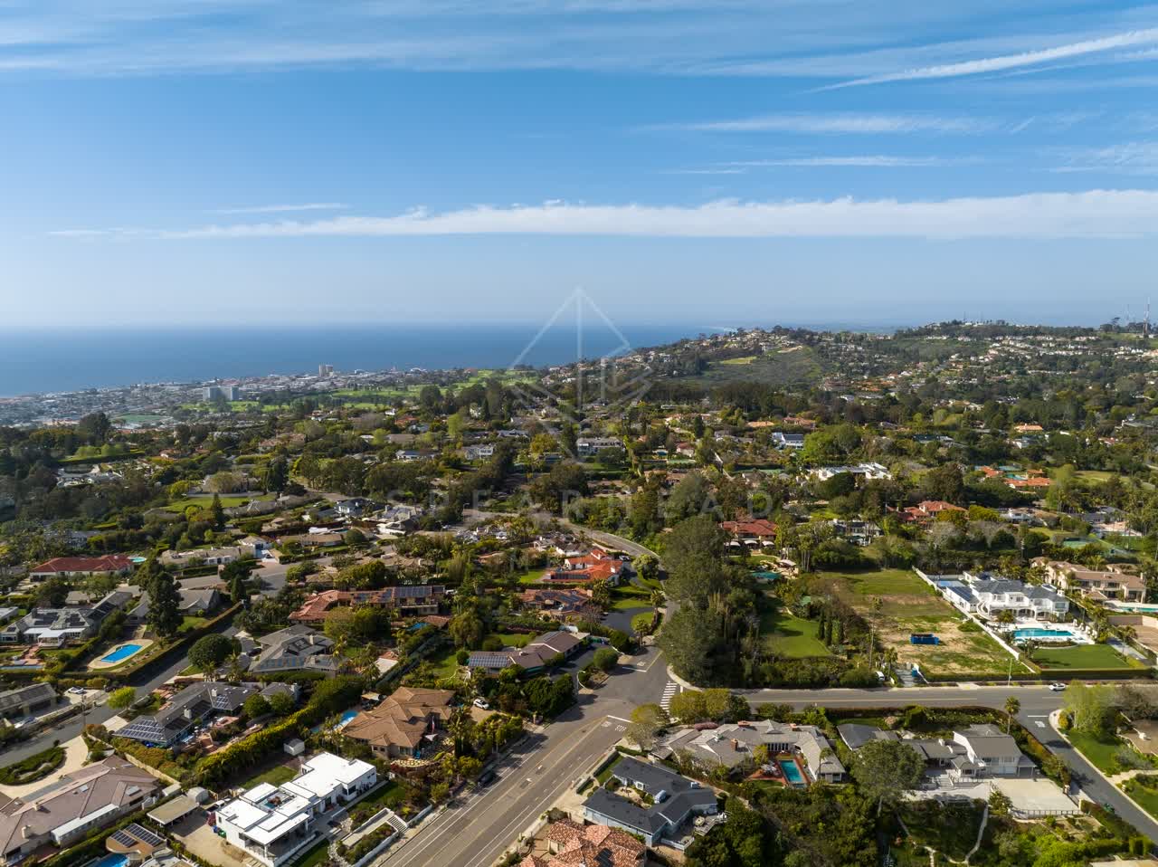 Aerial view of a residential street, the ocean and homes at La Jolla Mesa.