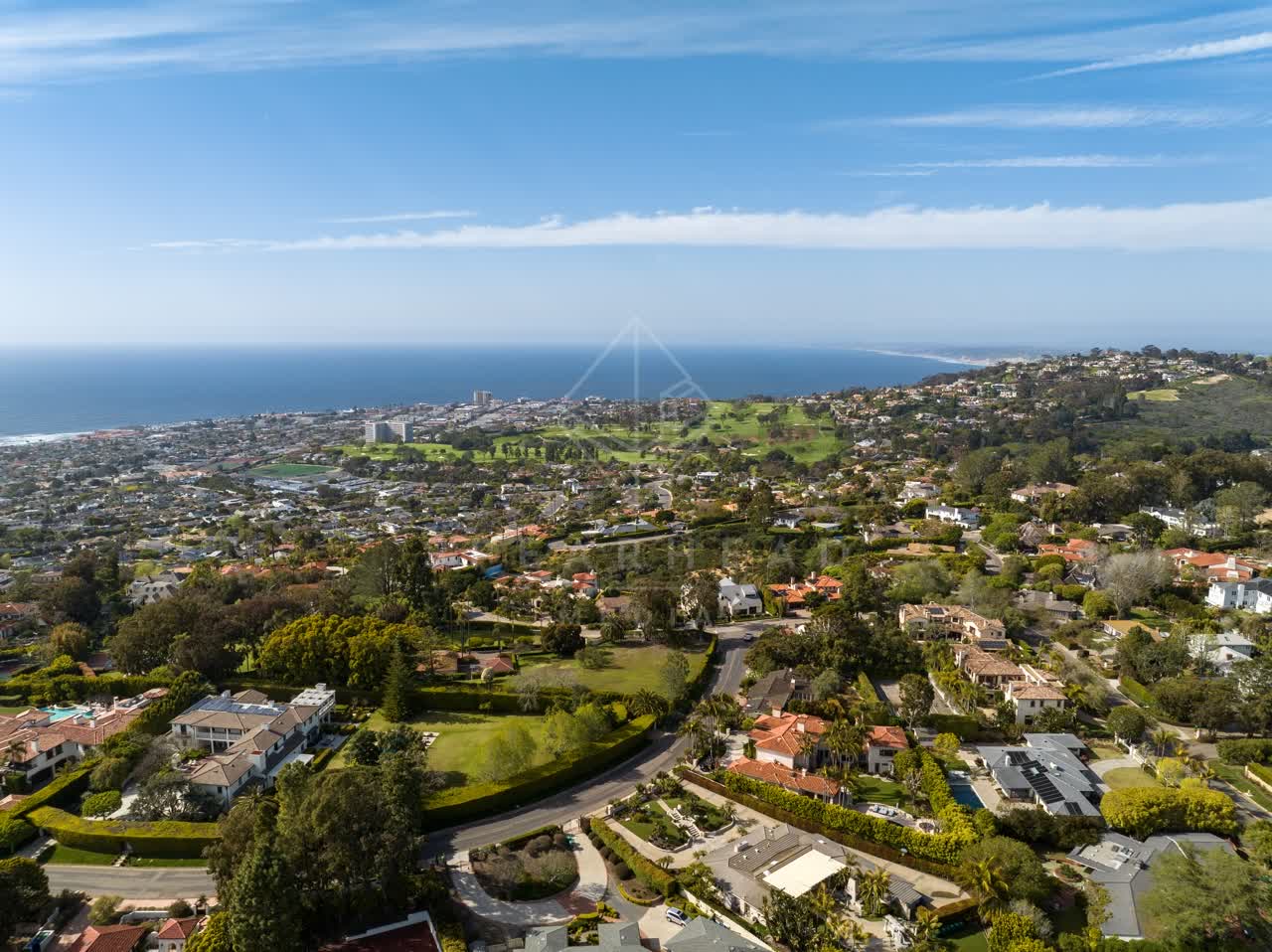 Aerial view of a residential street, the ocean and homes at La Jolla Mesa.