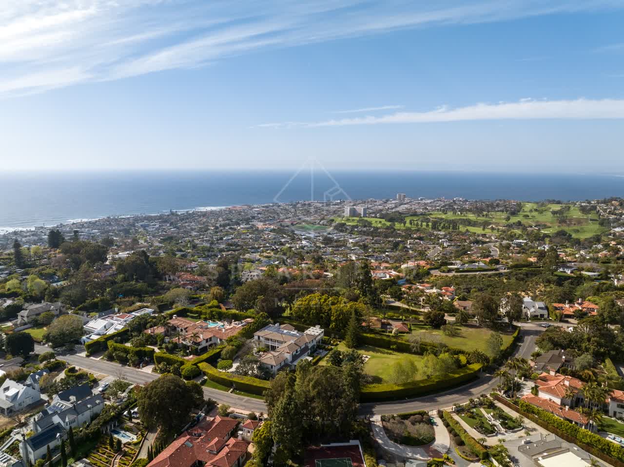 Aerial view of a residential street, the ocean and homes at La Jolla Mesa.