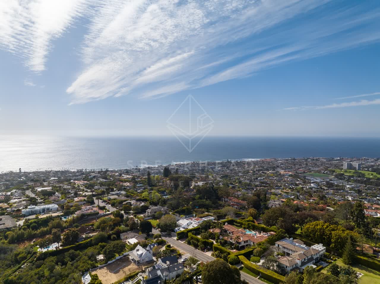 Aerial view of a residential street, the ocean and homes at La Jolla Mesa.