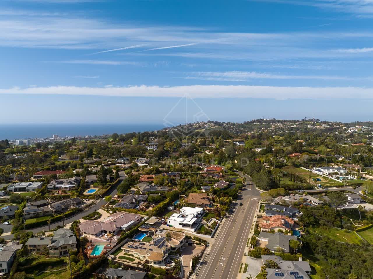 Aerial view of a residential street, the ocean and homes at La Jolla Mesa.
