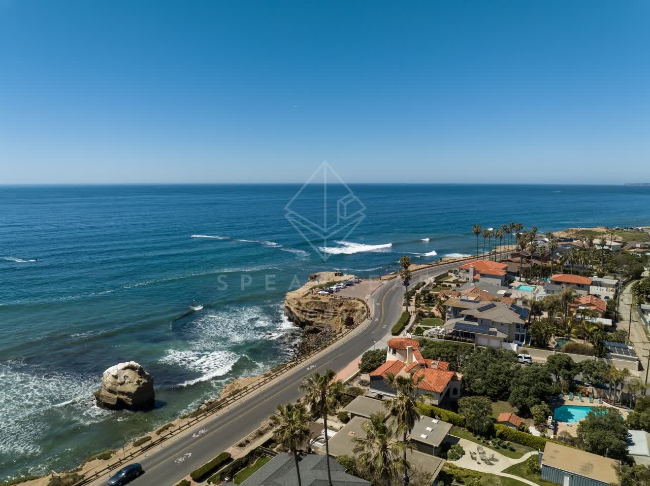 Aerial view of the cliffs, the surf and palm trees at Sunset Cliffs.