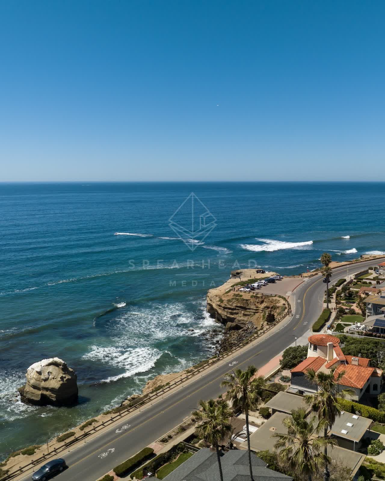 Aerial view of the cliffs, the surf and palm trees at Sunset Cliffs.