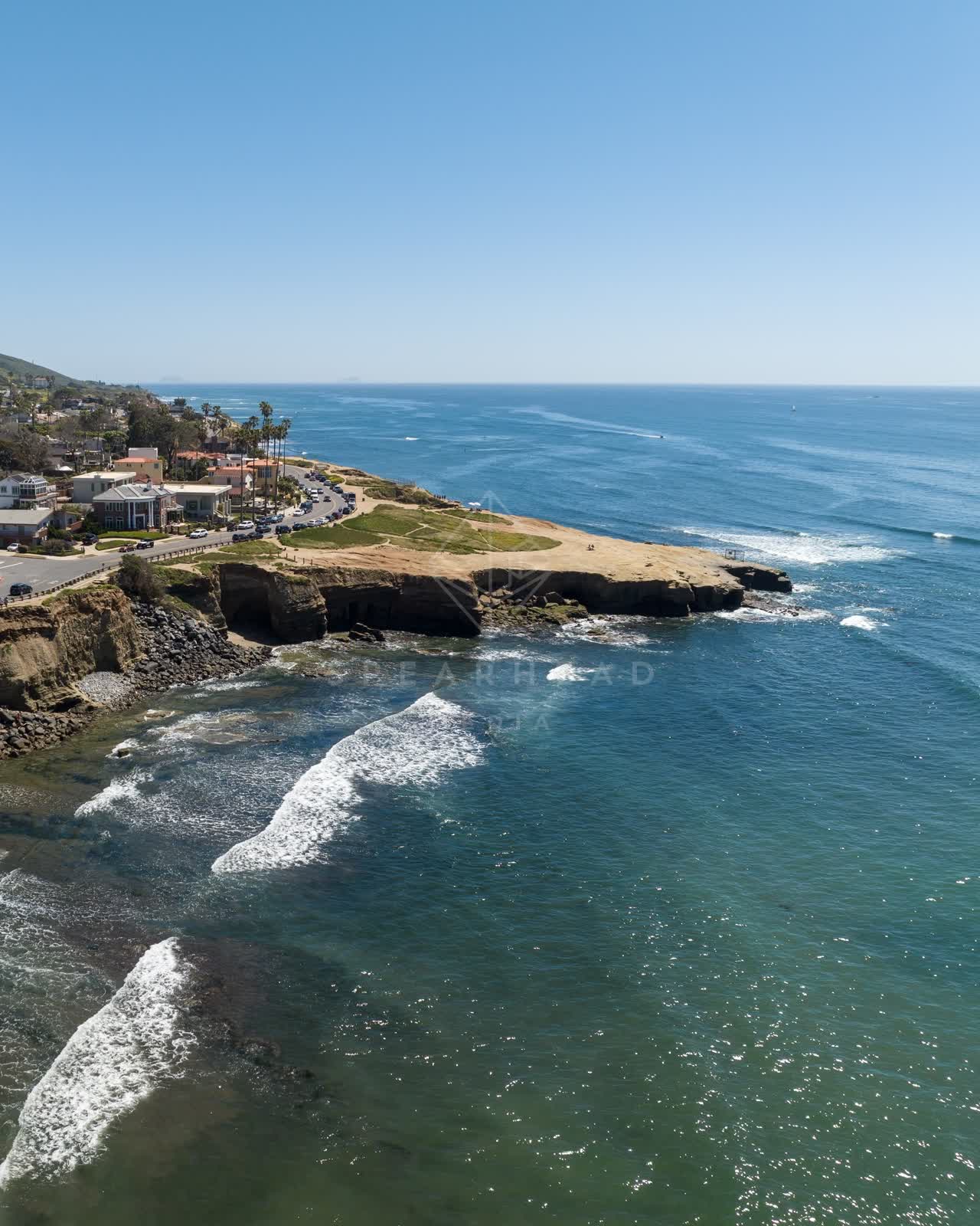 Aerial view of the cliffs, the surf and palm trees at Sunset Cliffs.