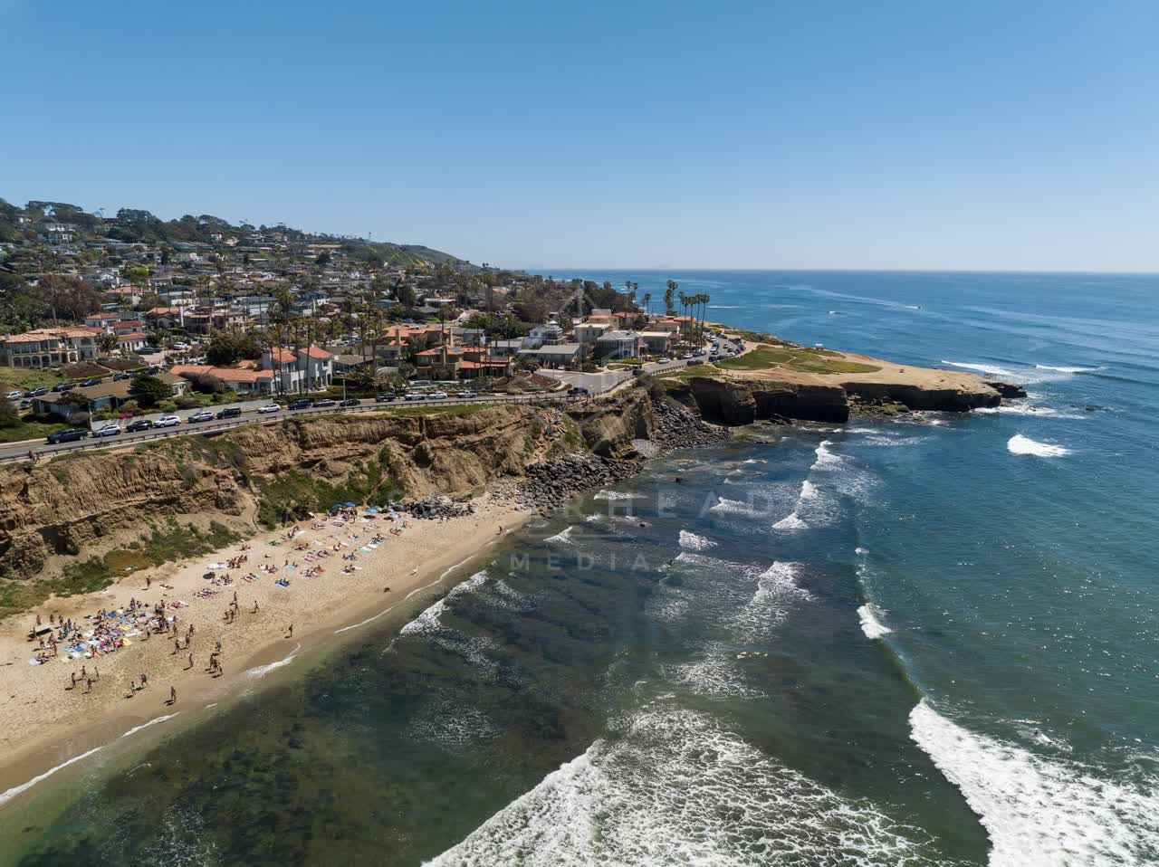 Aerial view of the cliffs, the surf and the ocean at Sunset Cliffs.