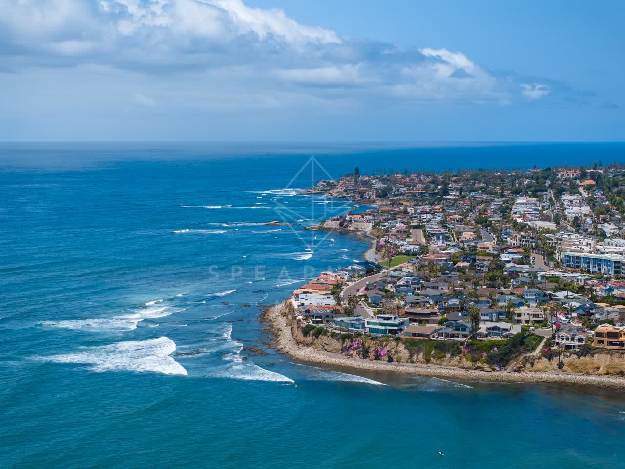 Aerial view of the cliffs, the surf and the ocean at Bird Rock.