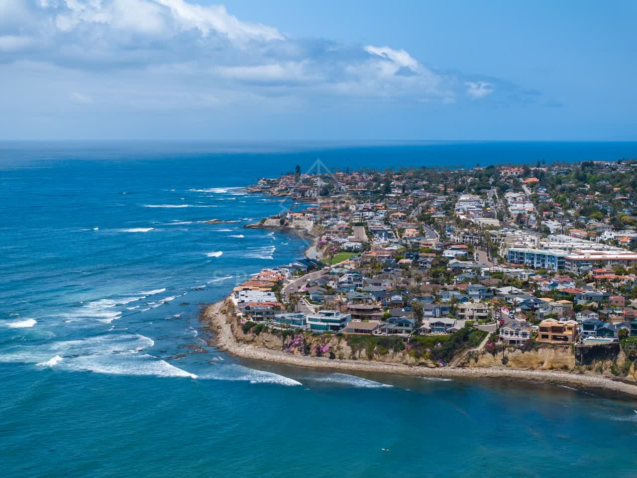 Aerial view of the cliffs, the surf and the ocean at Bird Rock.