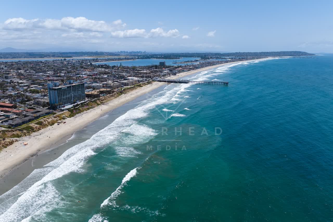 Aerial view of the beach, the surf and the pier at Tourmaline.