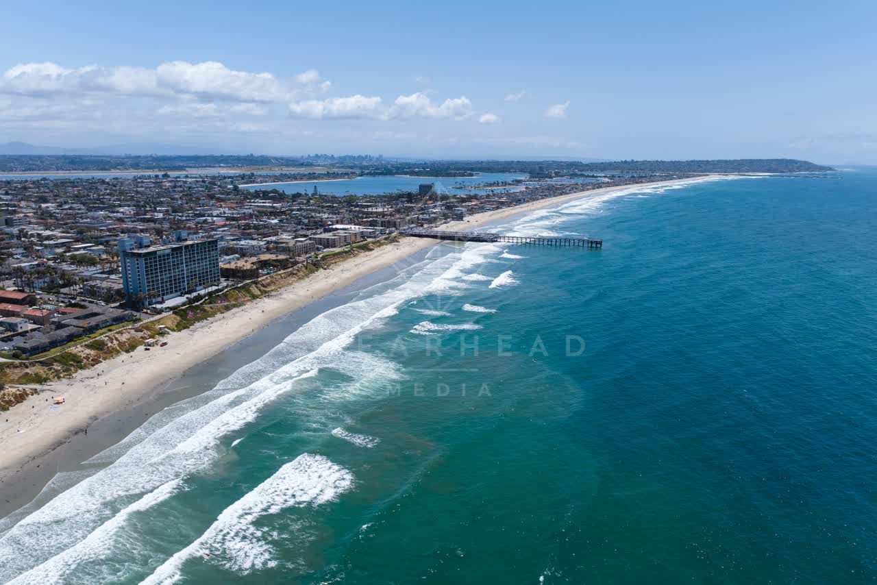 Aerial view of the beach, the surf and the pier at Tourmaline.