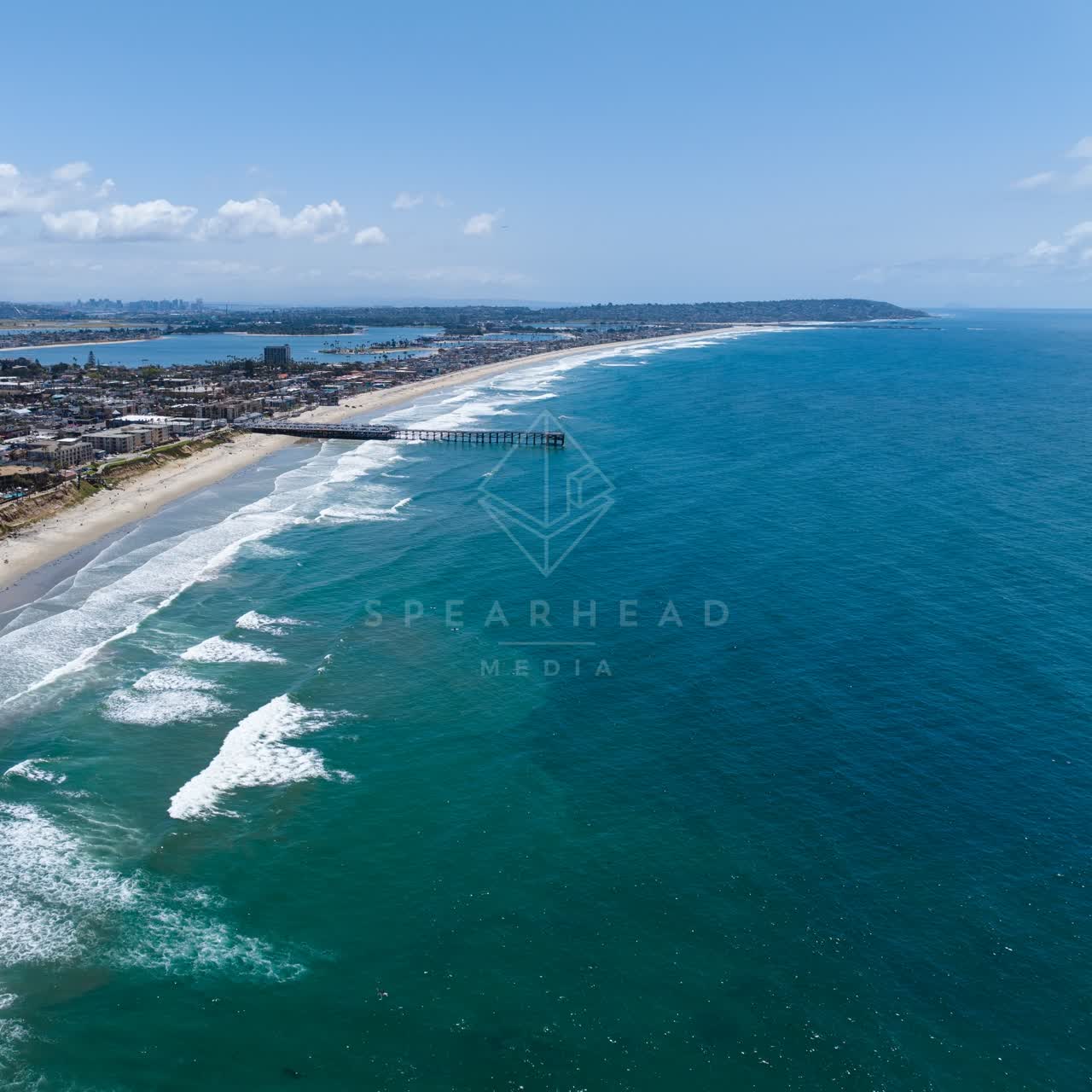 Aerial view of the beach, the surf and the pier at Tourmaline.