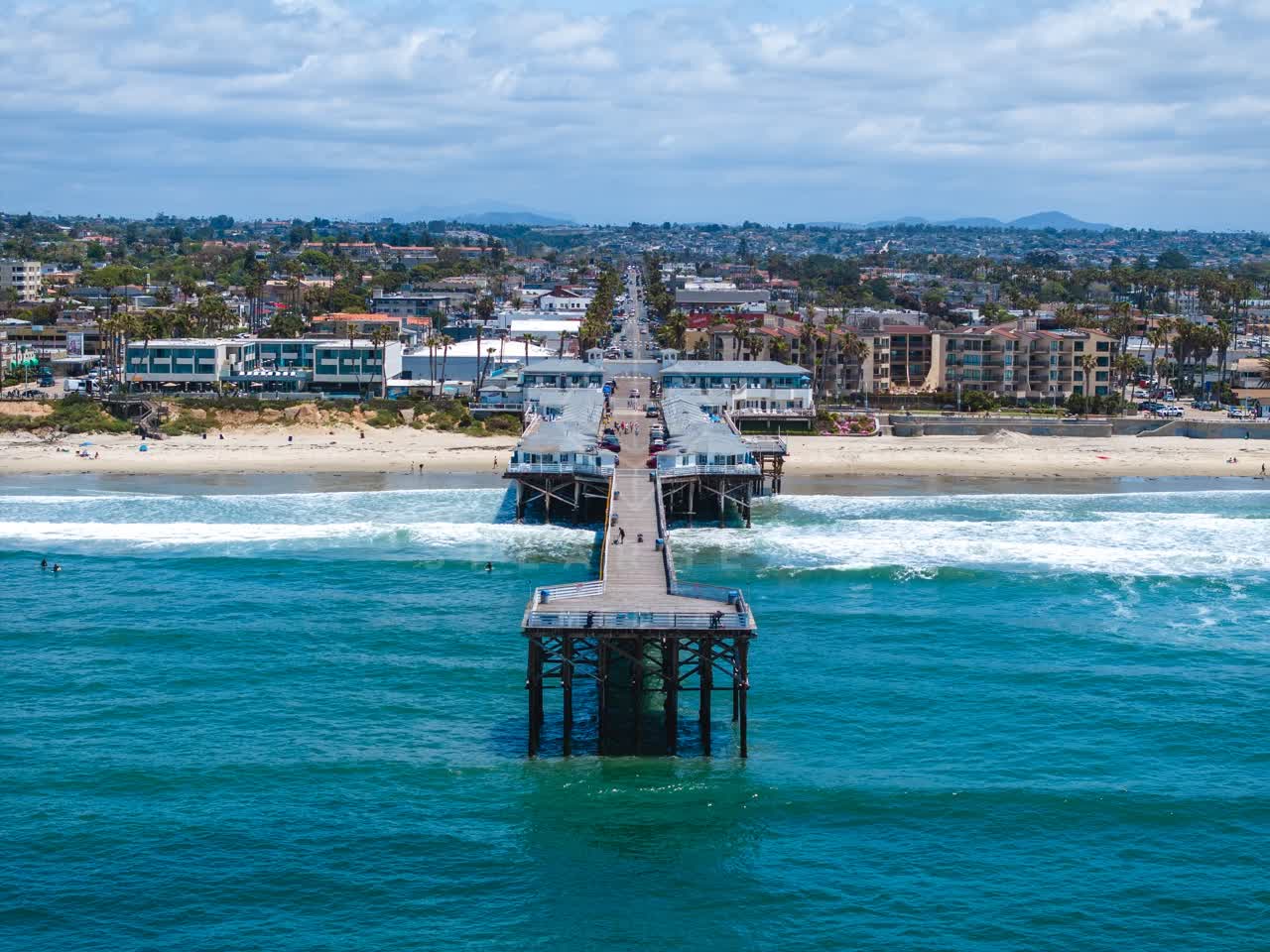 Aerial view of the beach, the surf and the pier in Pacific Beach.