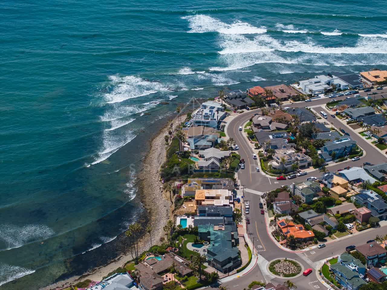 Aerial view of a residential street, the surf and palm trees at Bird Rock.