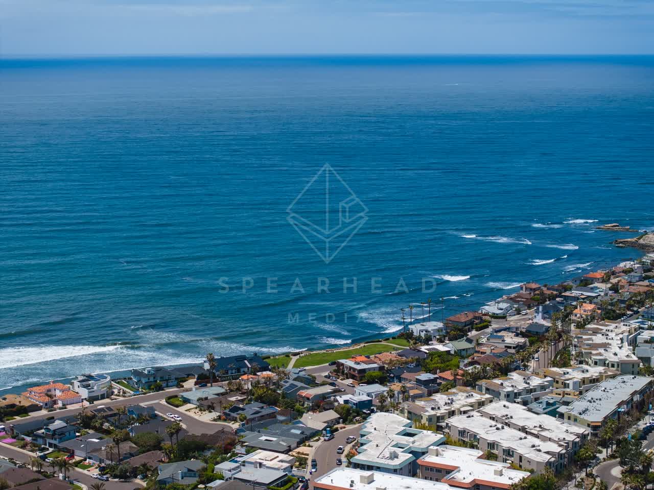 Aerial view of a residential street, the surf and palm trees at Bird Rock.