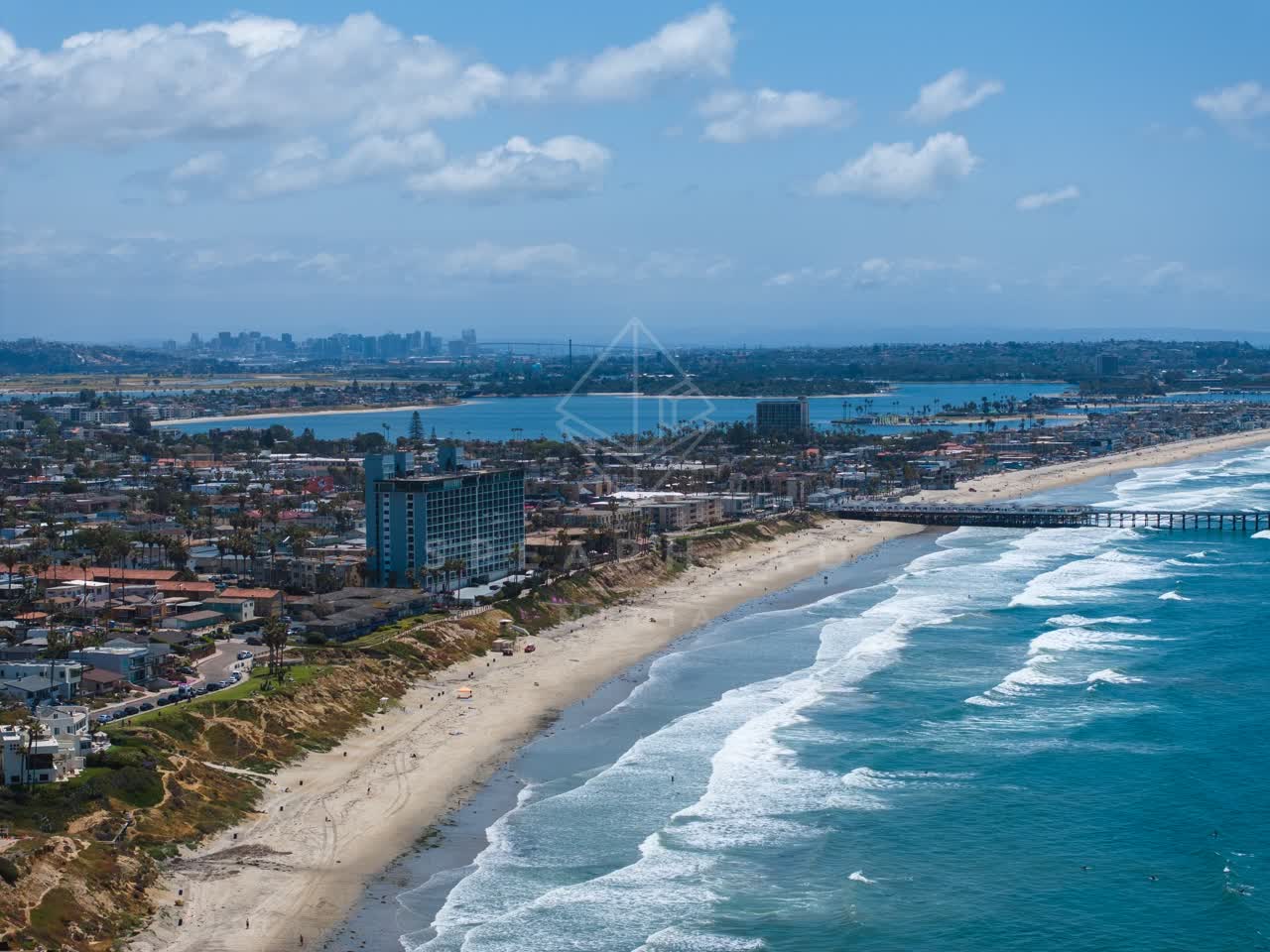Aerial view of the beach, the surf and the pier at Tourmaline.