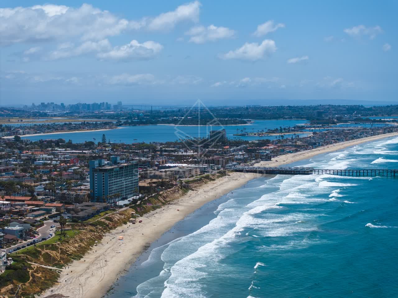 Aerial view of the beach, the surf and the pier at Tourmaline.