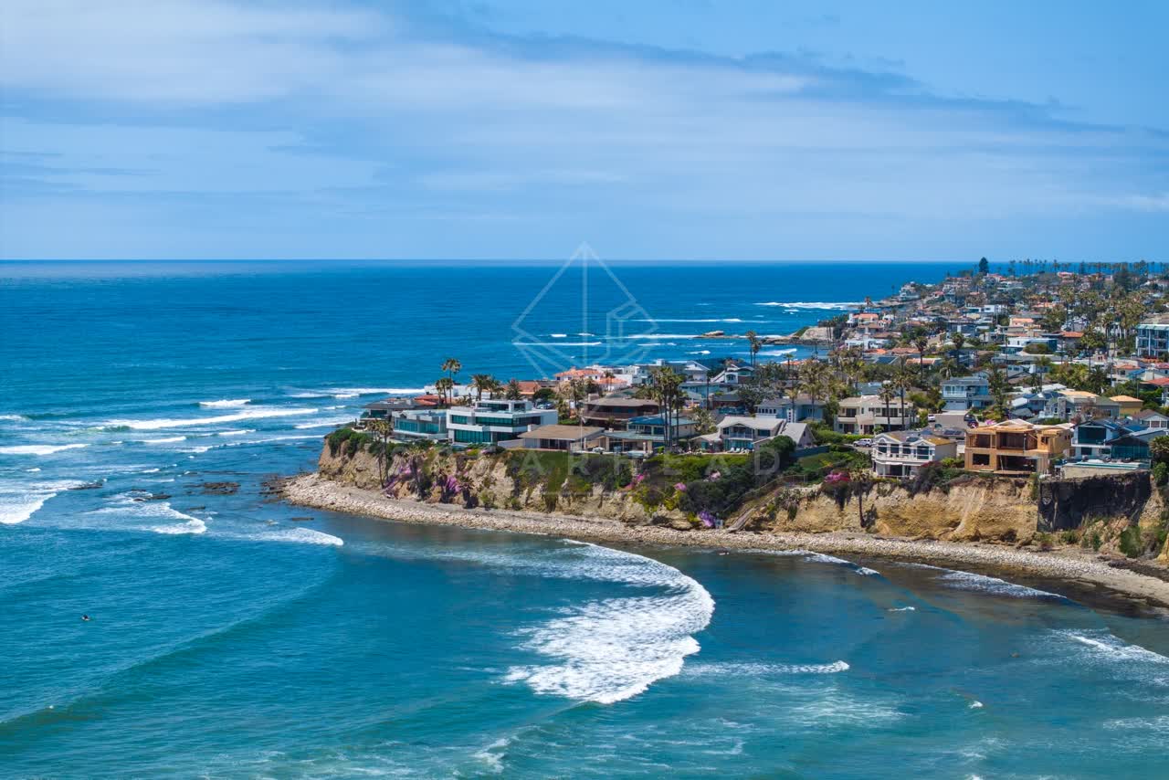 Aerial view of the cliffs, the surf and palm trees at Bird Rock.