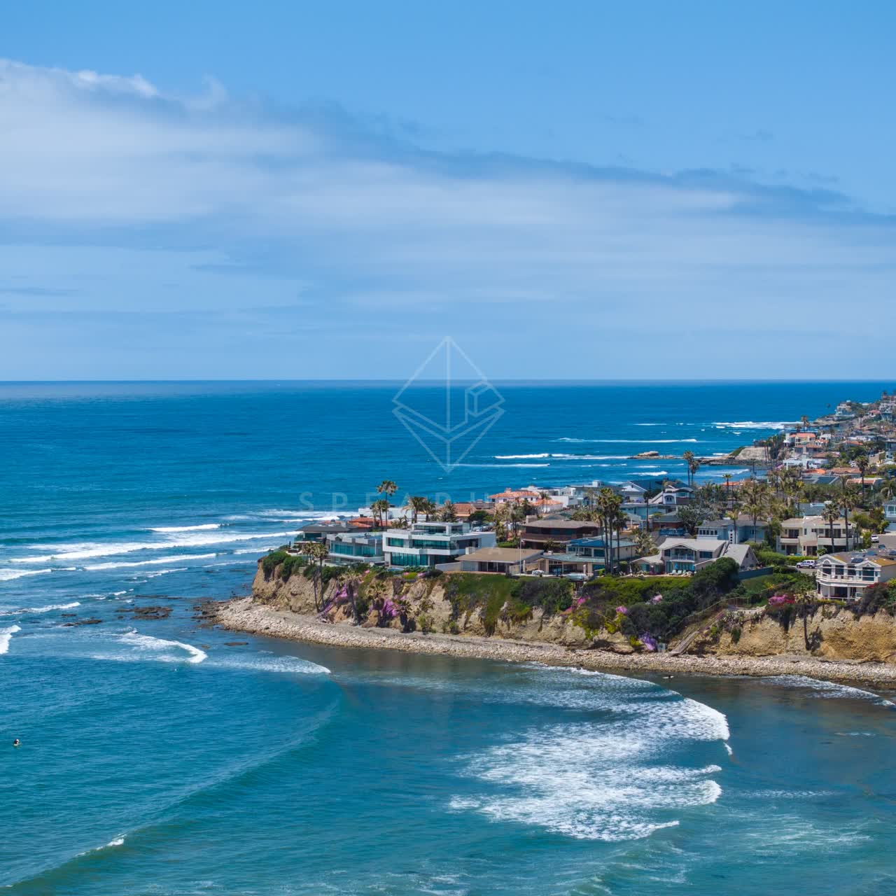 Aerial view of the cliffs, the surf and the ocean at Bird Rock.