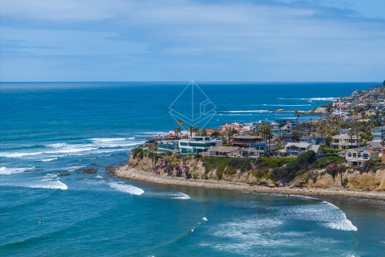 Aerial view of the cliffs, the surf and palm trees at Bird Rock.