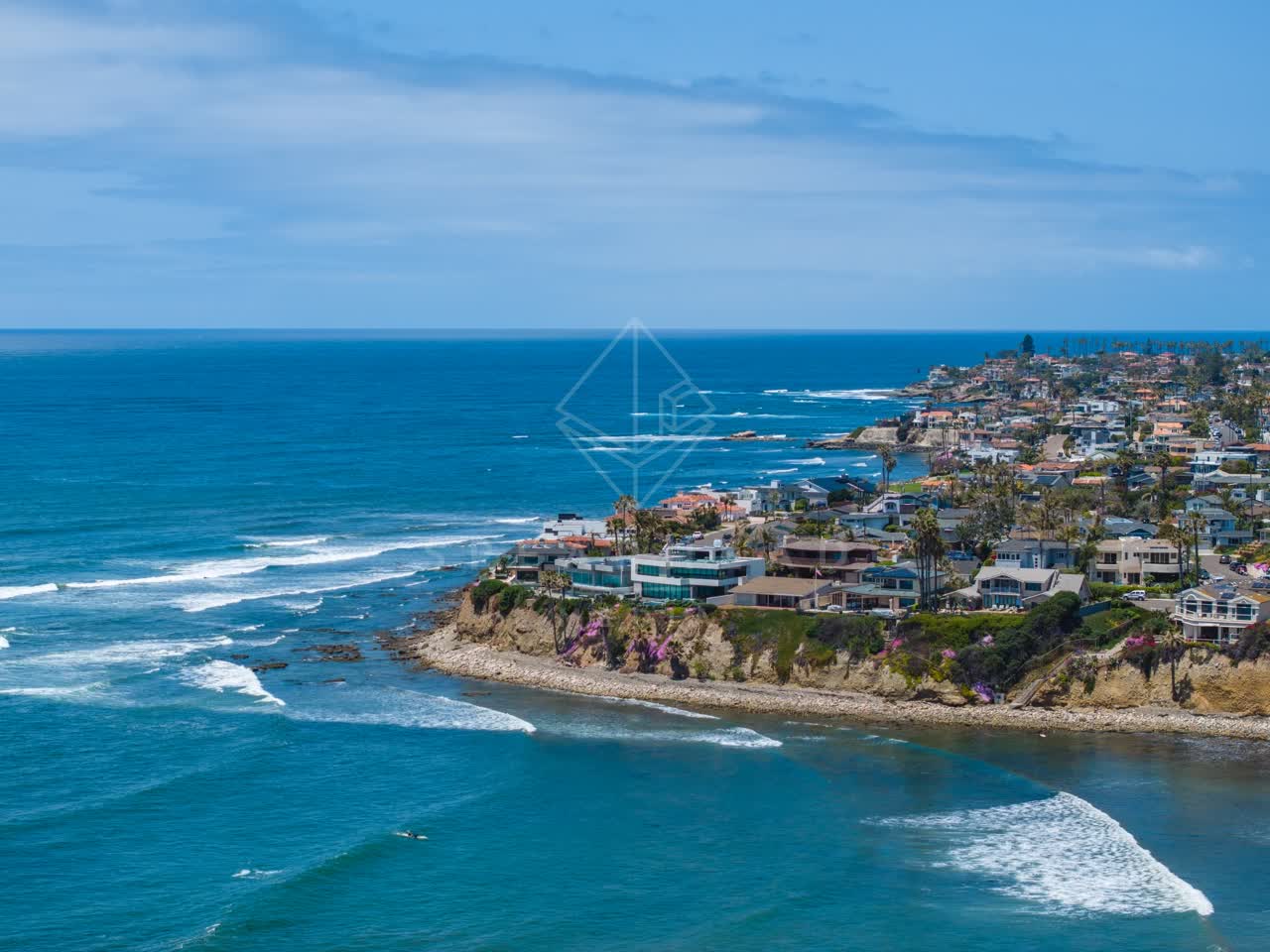 Aerial view of the cliffs, the surf and palm trees at Bird Rock.