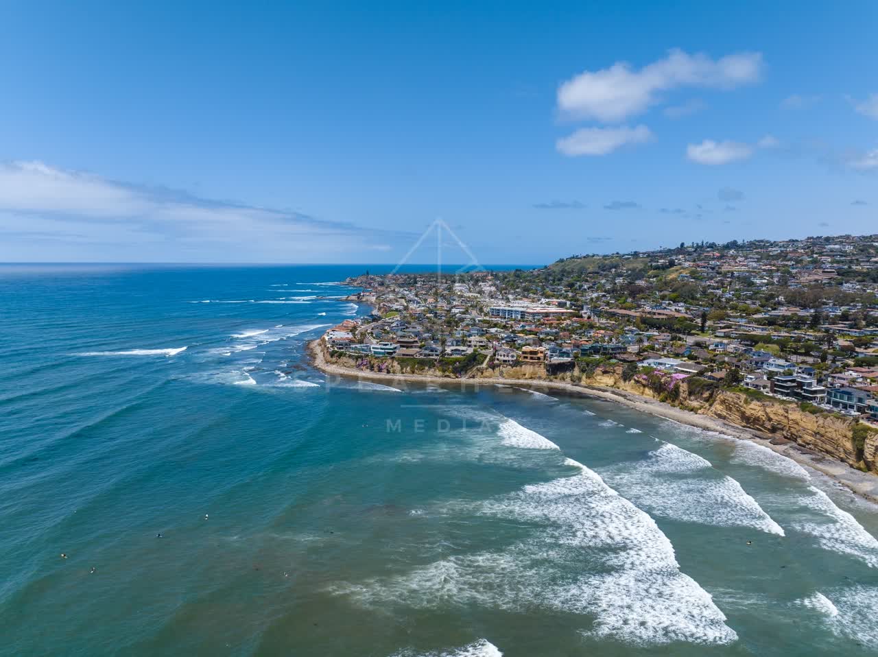 Aerial view of the cliffs, the surf and the ocean at Tourmaline.