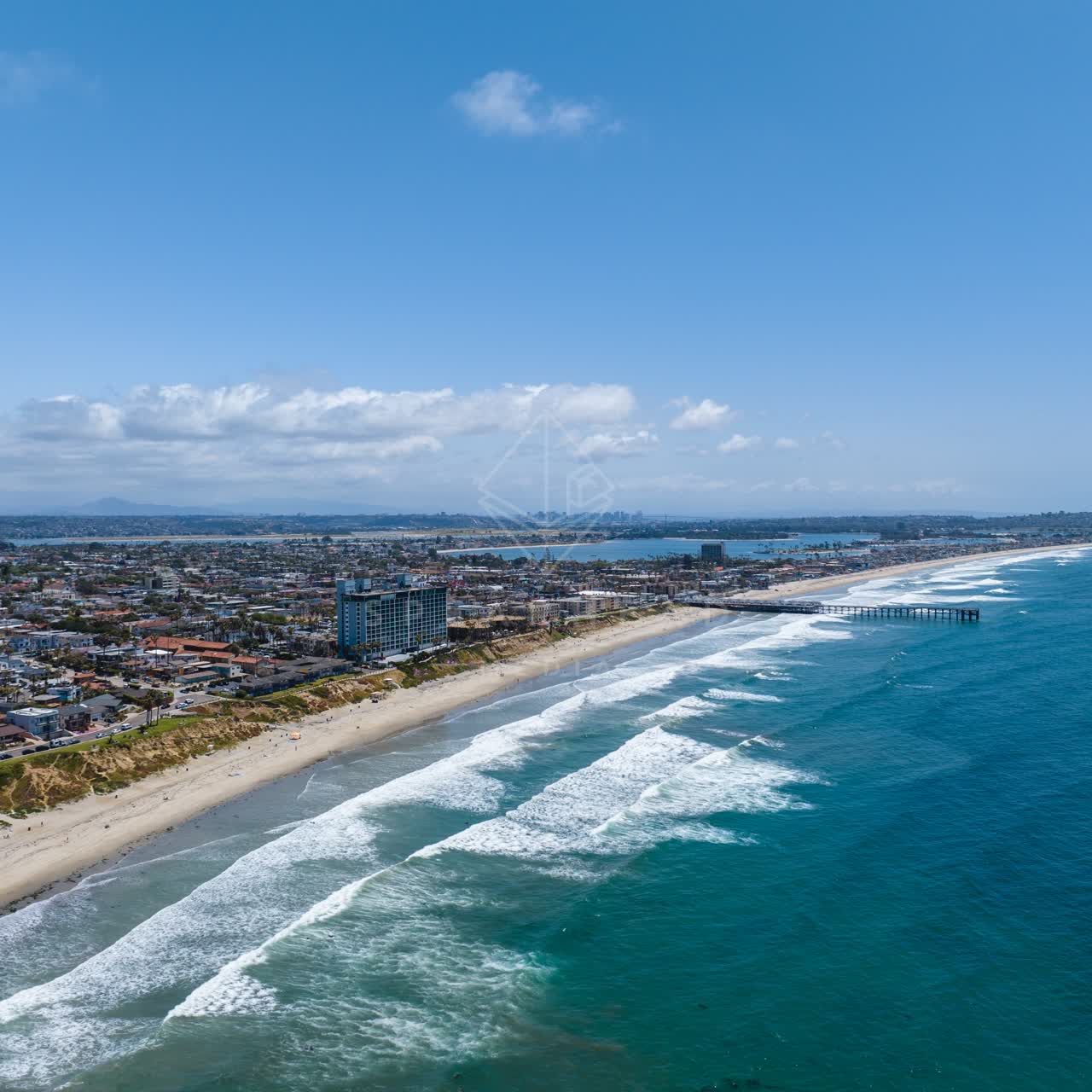 Aerial view of the beach, the surf and the pier at Tourmaline.