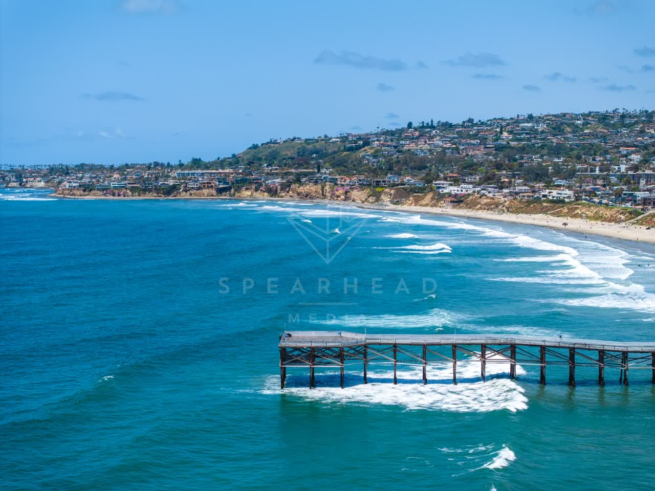 Aerial view of the beach, the surf and the pier in Pacific Beach.