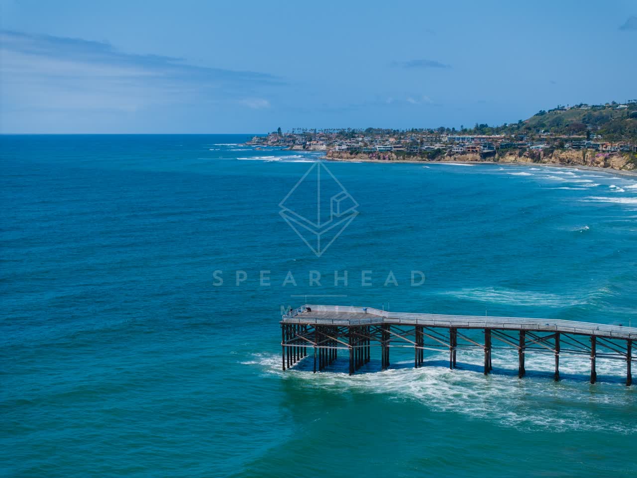 Aerial view of the beach, the surf and the pier in Pacific Beach.
