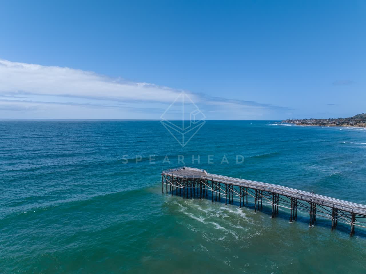 Aerial view of the beach, the surf and the pier in Pacific Beach.