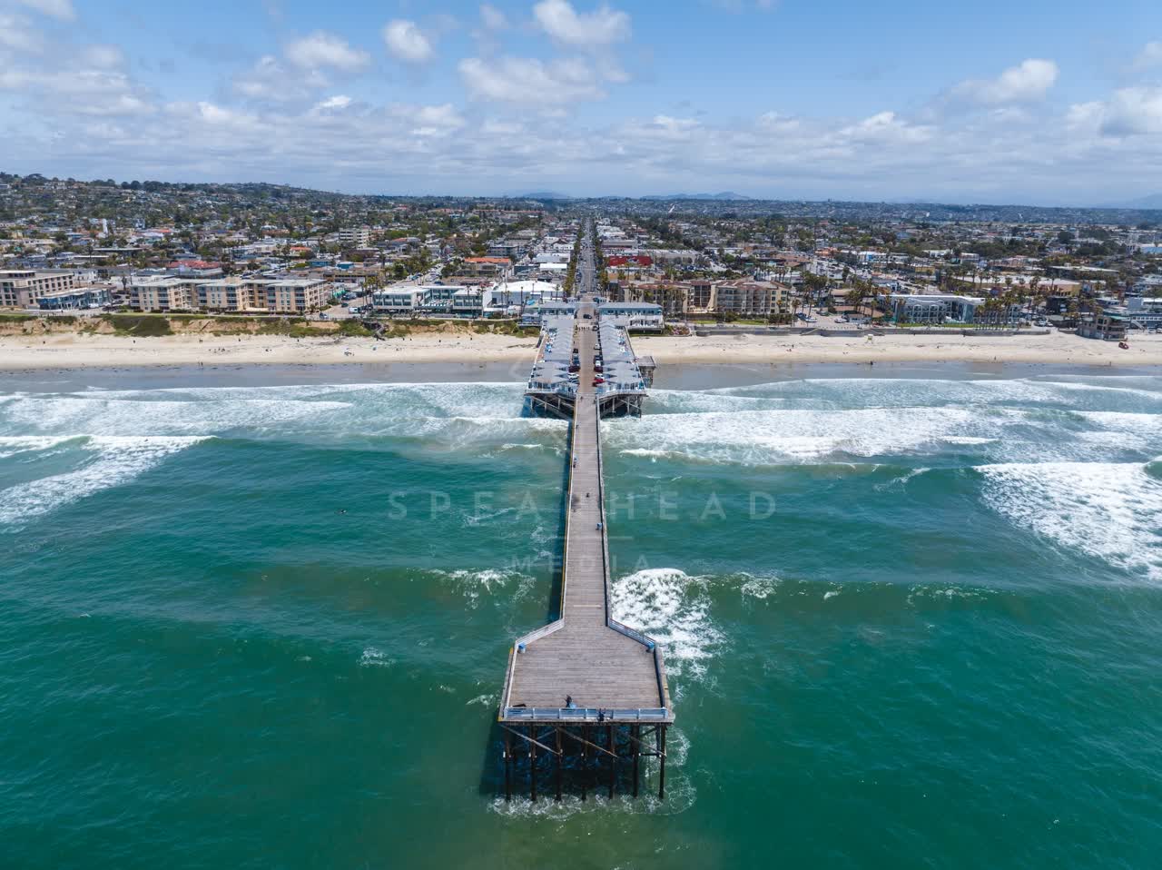 Aerial view of the beach, the surf and the pier in Pacific Beach.