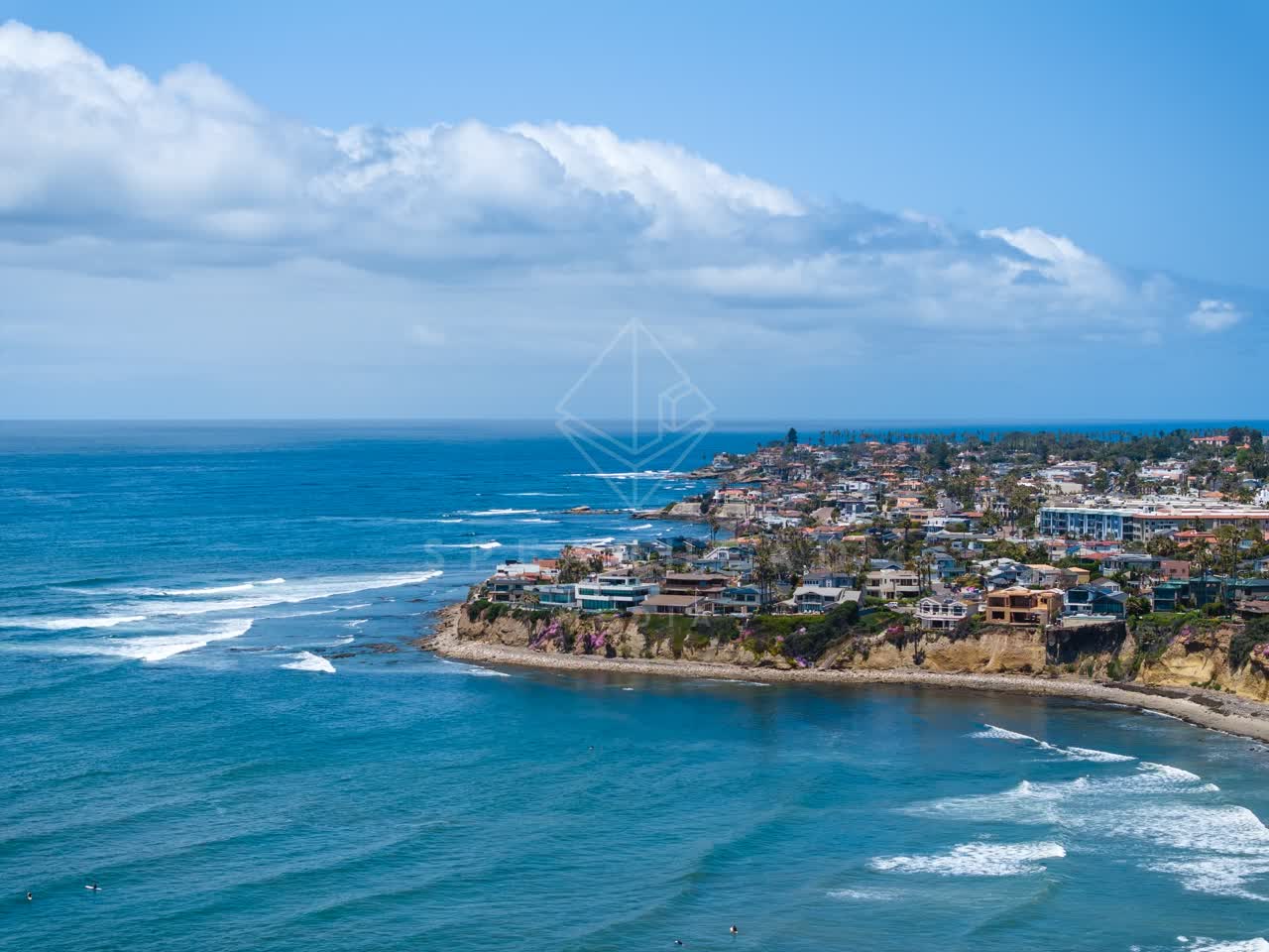 Aerial view of the cliffs, the surf and the ocean at Bird Rock.