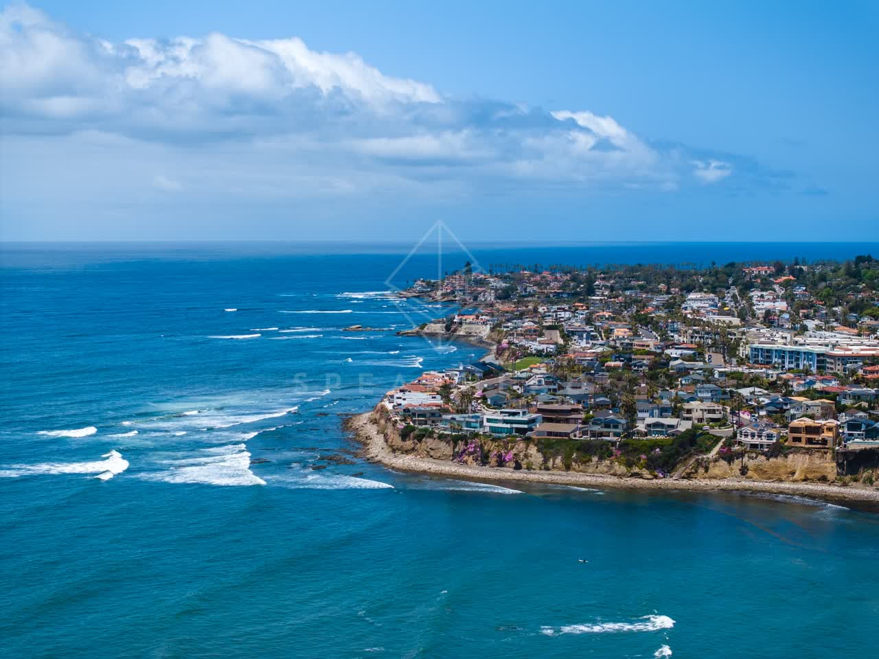 Aerial view of the cliffs, the surf and the ocean at Bird Rock.