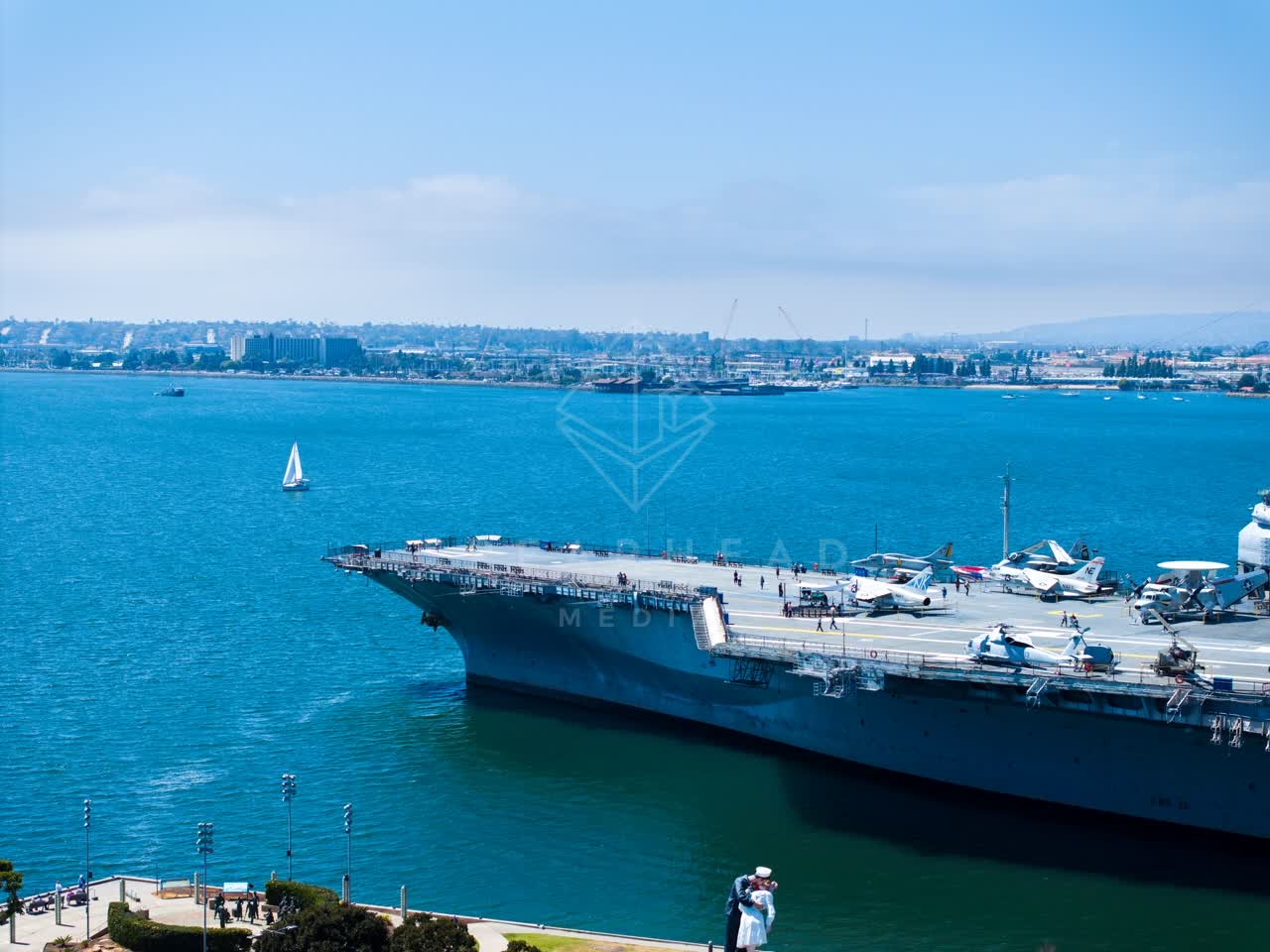 Aerial view of the harbor, boats and the bay at Embarcadero, with a work crew on site.