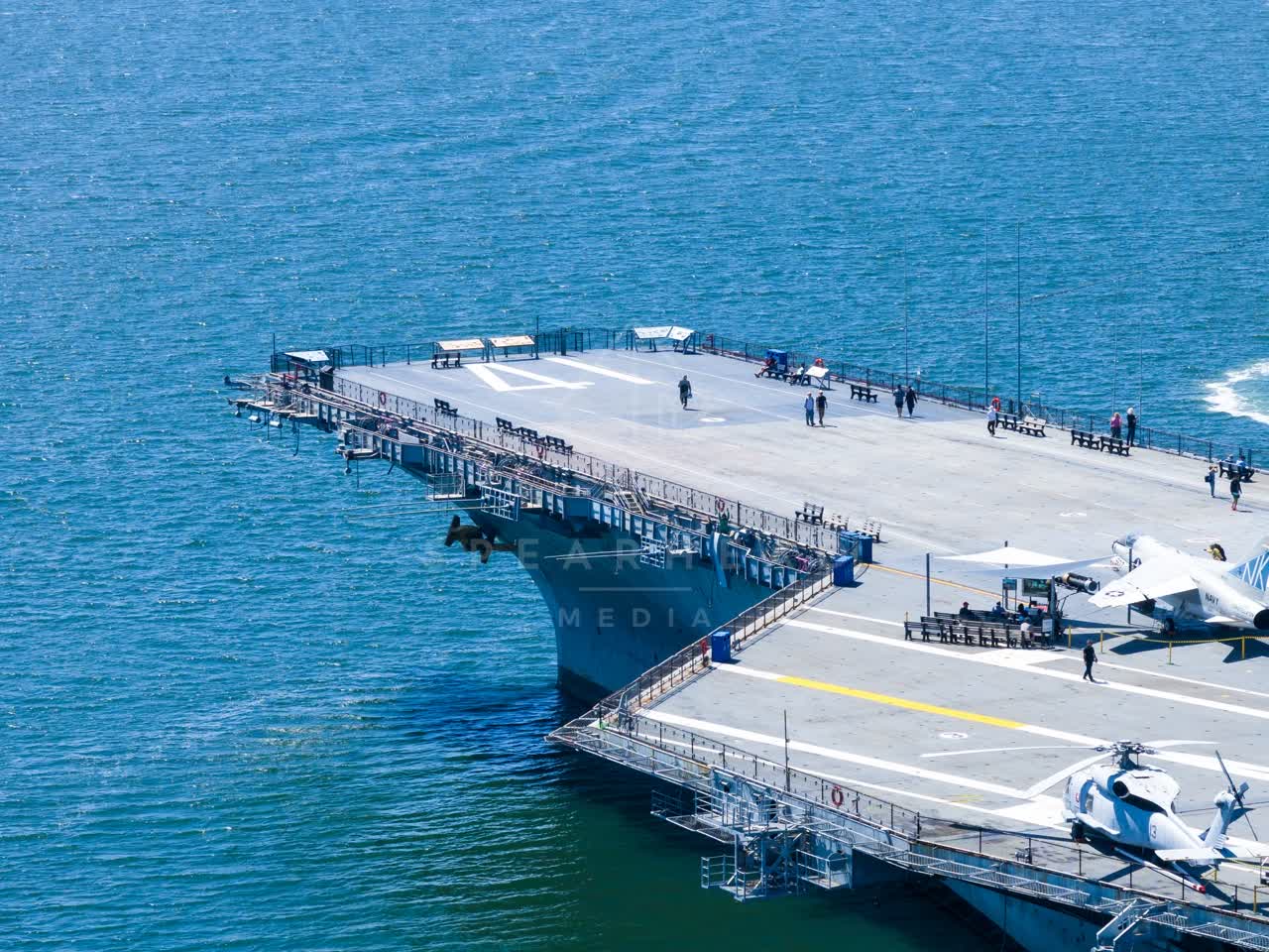 Aerial view of the harbor, boats and the bay at Embarcadero, with people walking.