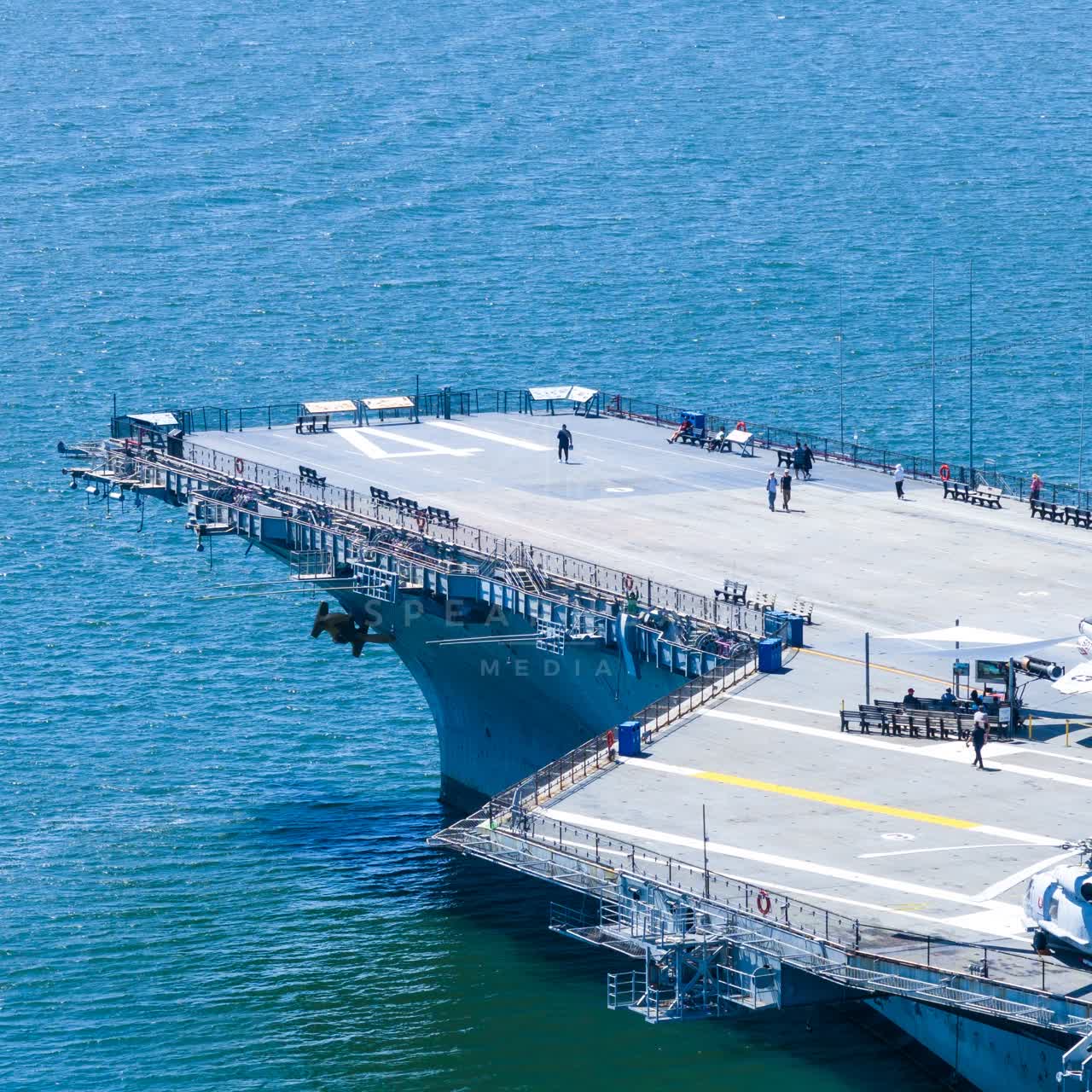 Aerial view of the harbor, boats and the bay at Embarcadero, with people walking.