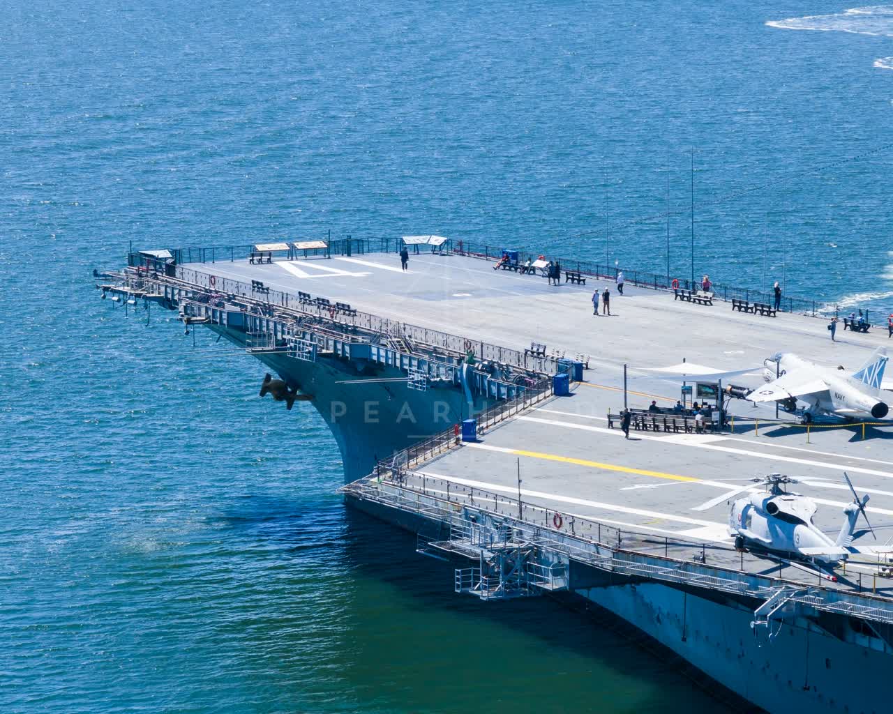 Aerial view of the harbor, boats and the bay at Embarcadero, with people walking.