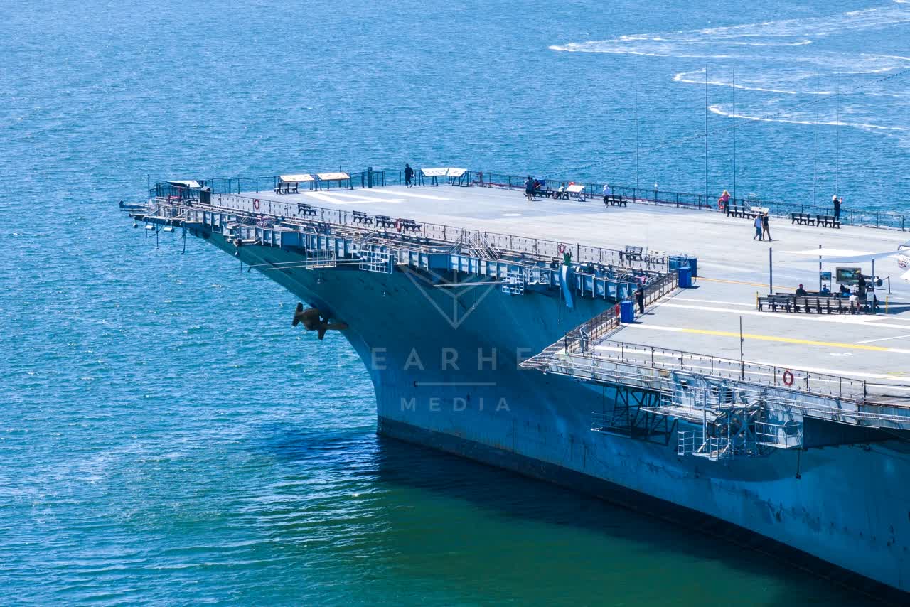 Aerial view of the harbor, boats and the bay at Embarcadero, with people walking.