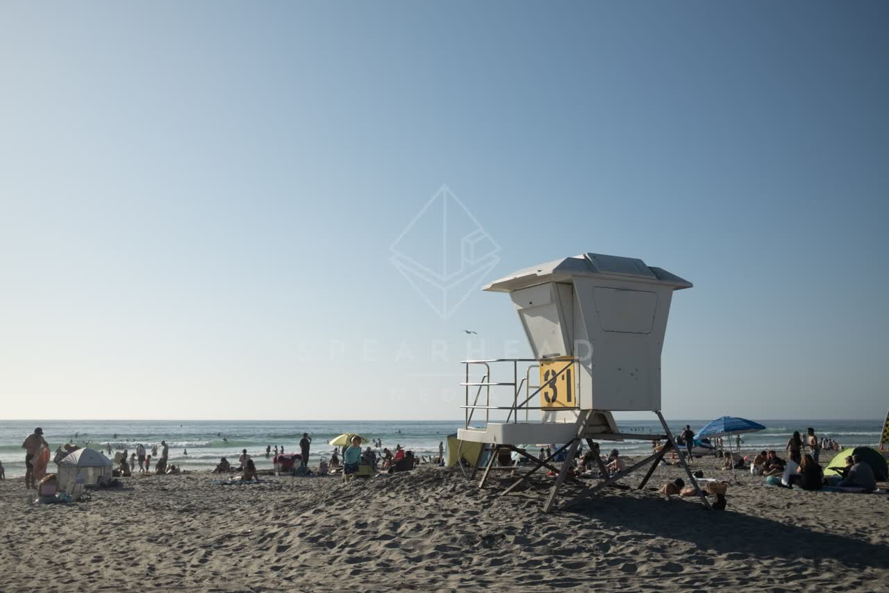 The beach, the ocean and open country at La Jolla Shores, with a crowd gathered.