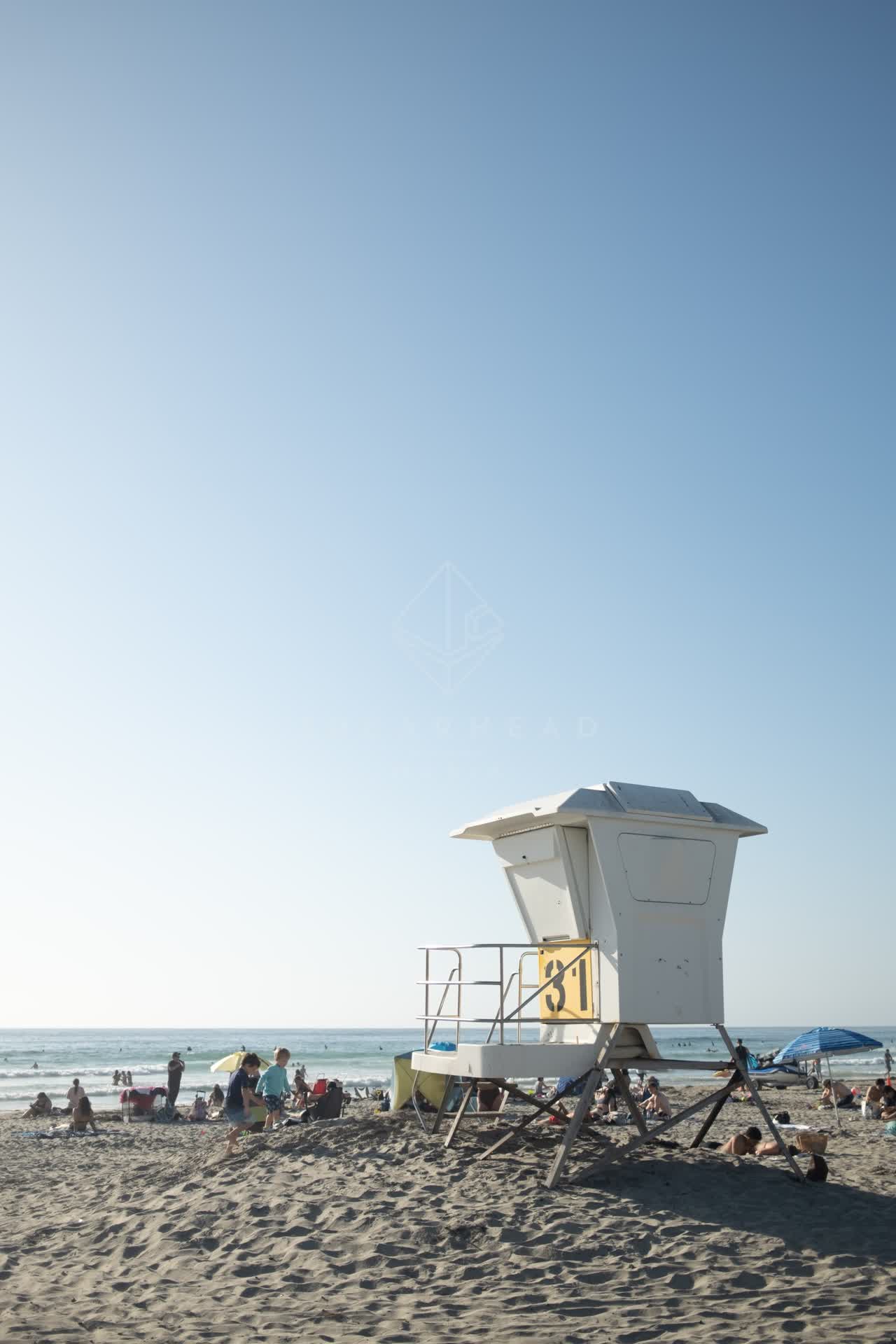 The beach, the ocean and the water at La Jolla Shores, with a crowd gathered.