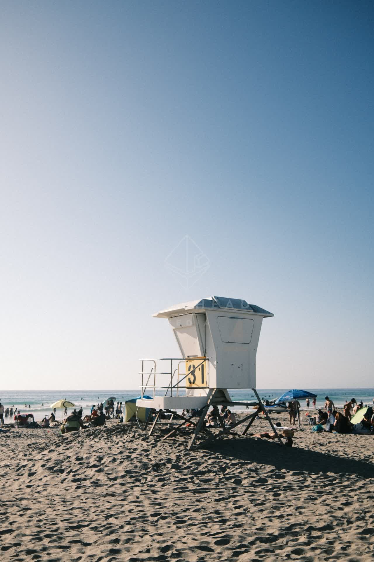 The beach, the ocean and the water at La Jolla Shores, with a crowd gathered.