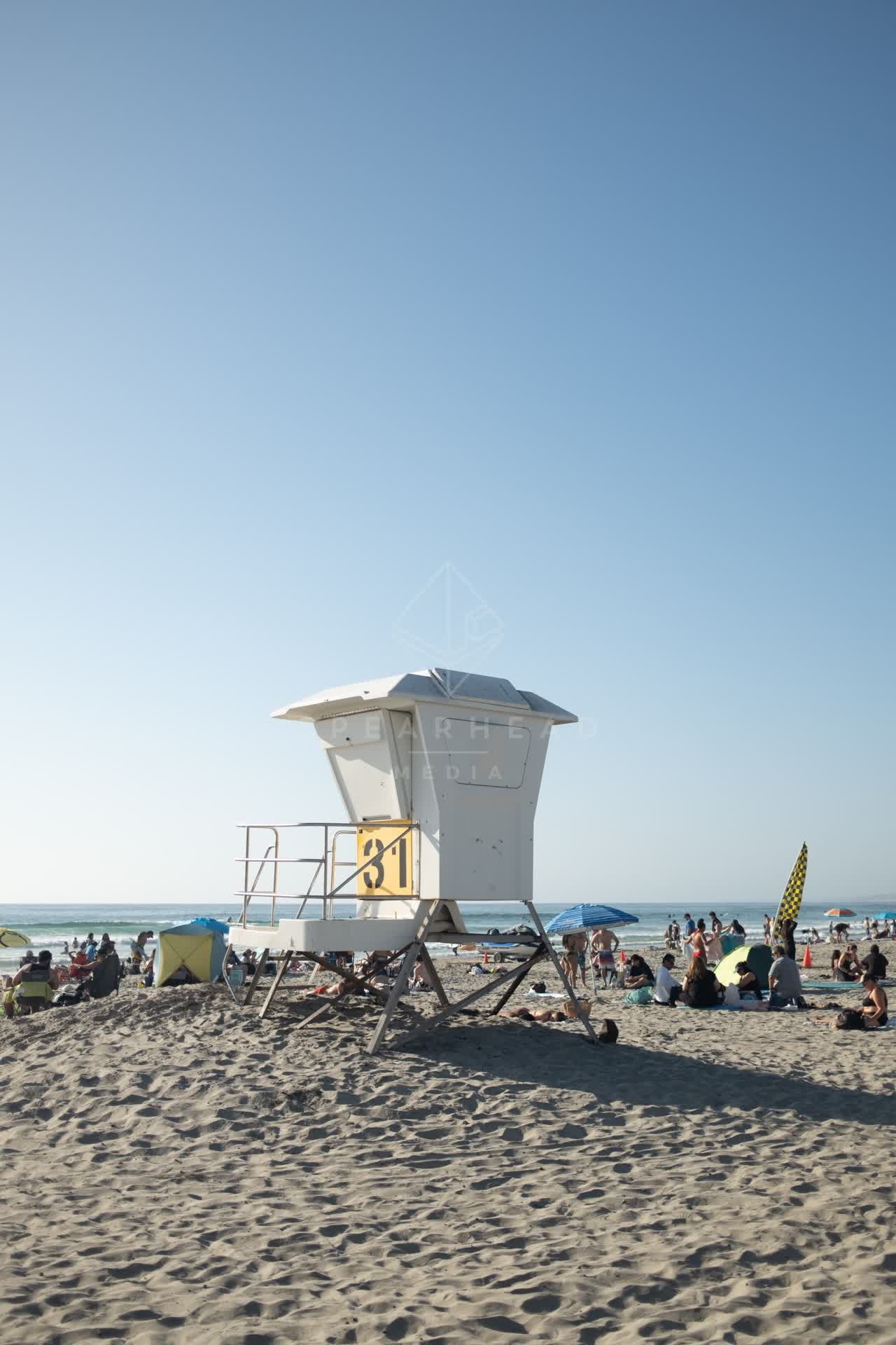 The beach, the surf and the ocean at La Jolla Shores, with a crowd gathered.